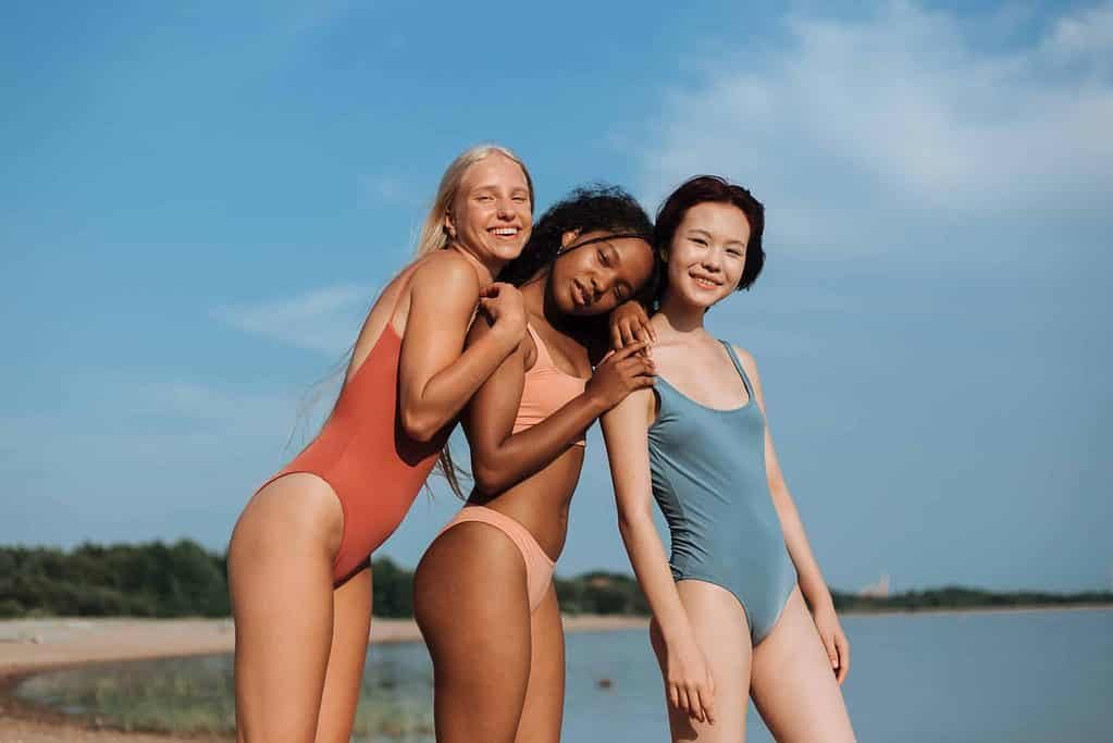 3 women in black swimsuits